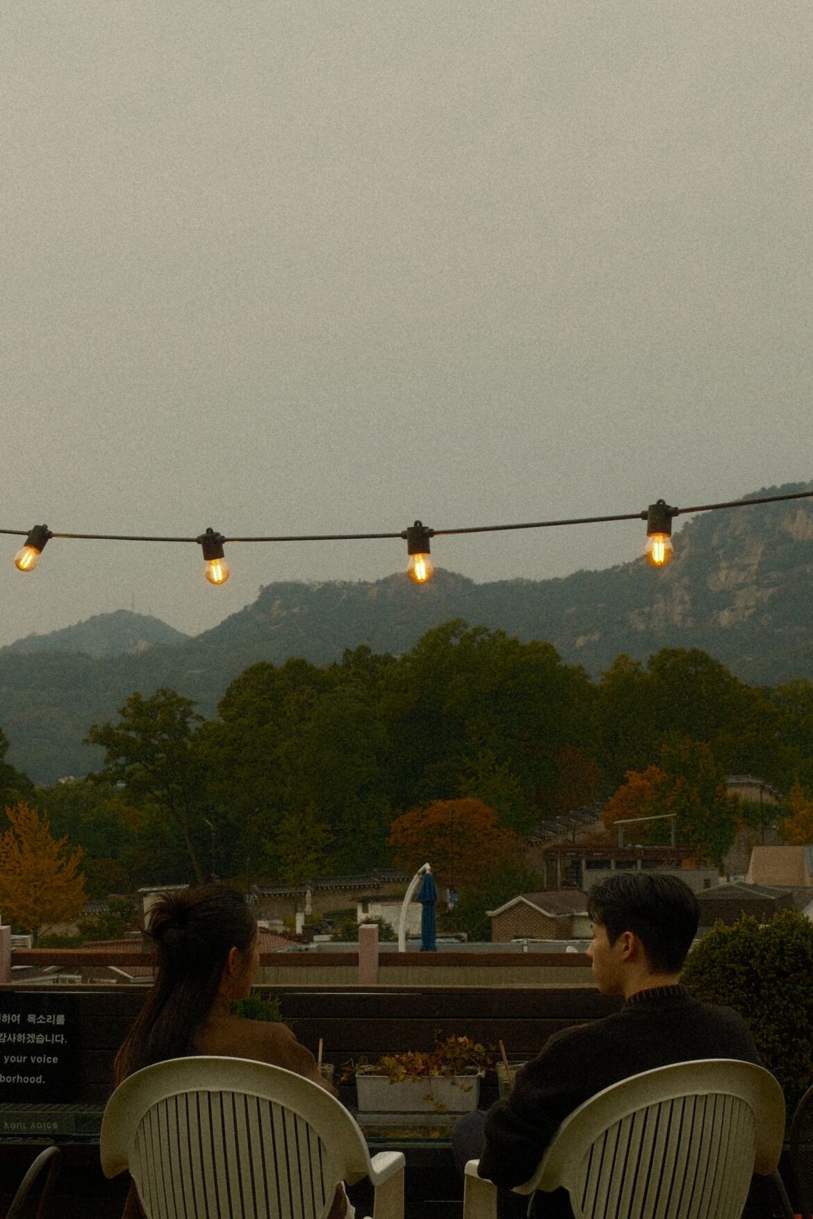 Couple enjoying an evening date on a Seoul rooftop