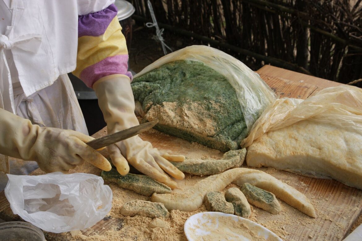 Traditional Korean rice cake preparation at a street stall