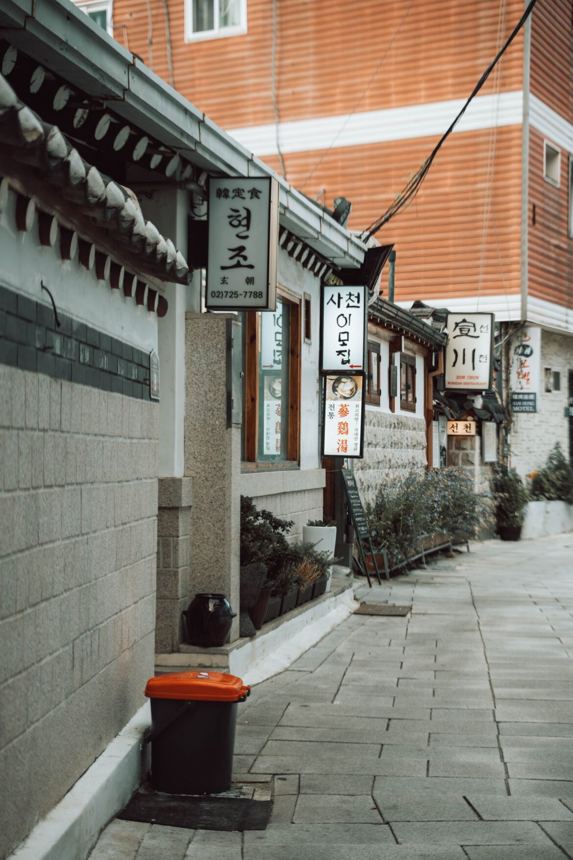 A neighborhood street lined with traditional hanok houses in Seoul