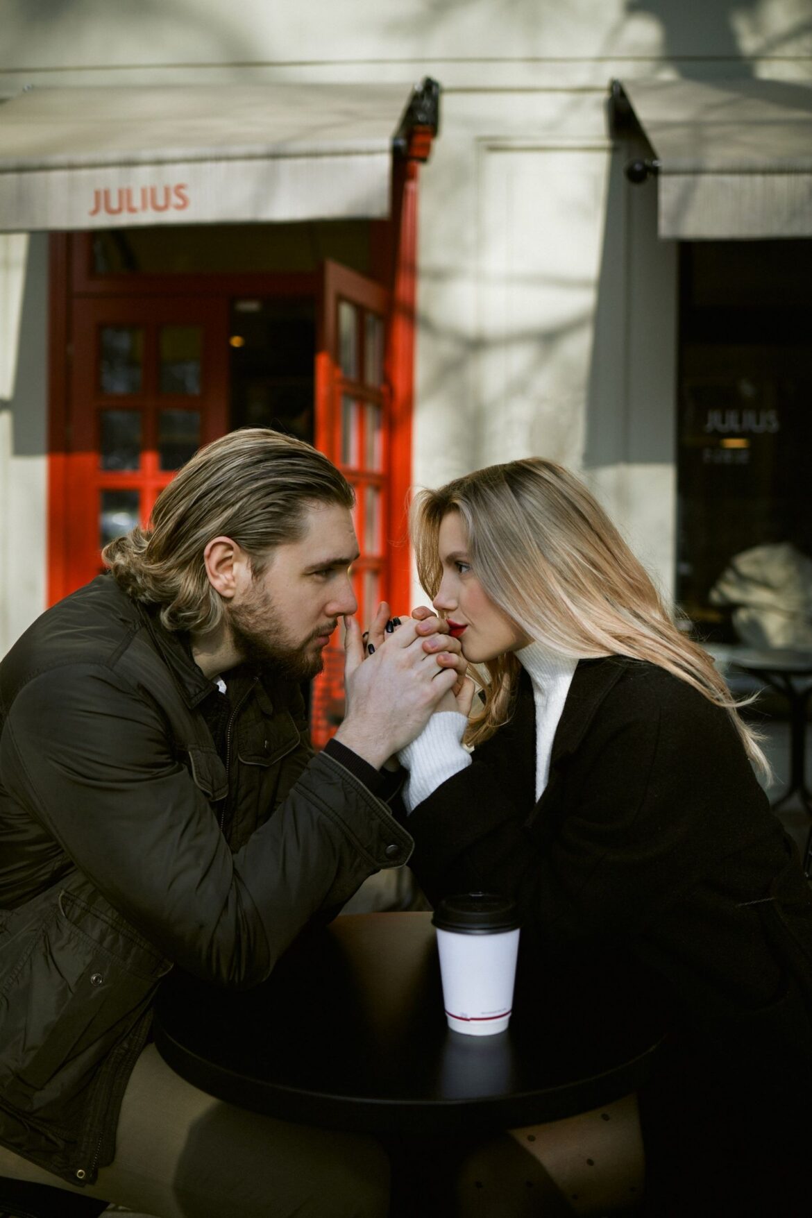 Couple holding hands at cafe