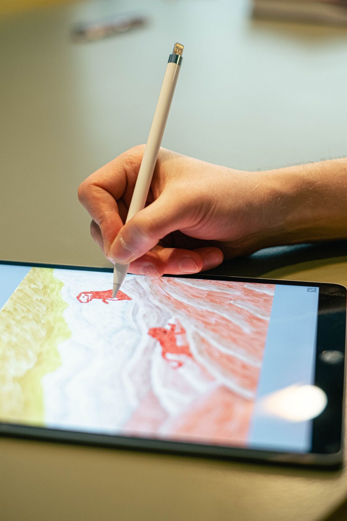 Close-up of hand drawing on tablet screen with stylus showcasing digital artistry
