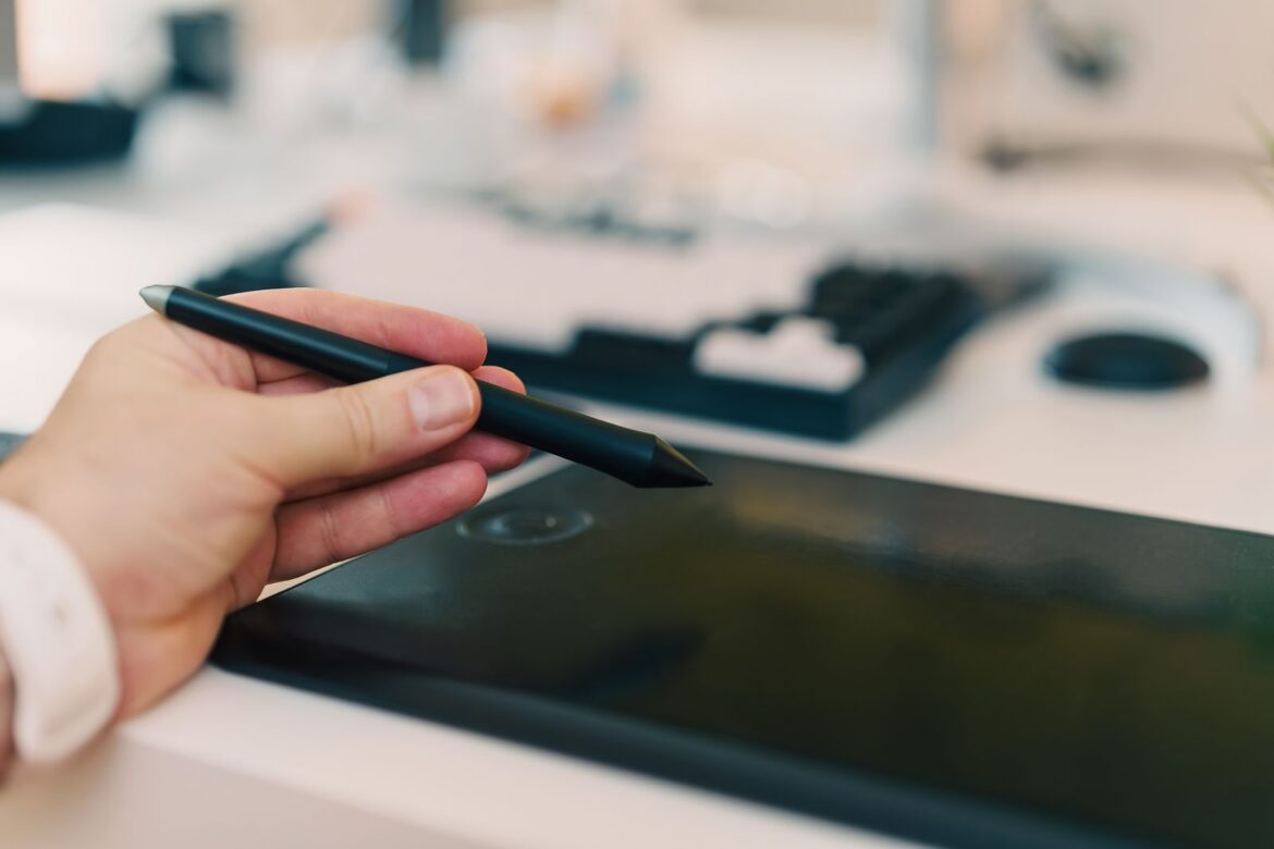 Artist using stylus on digital tablet