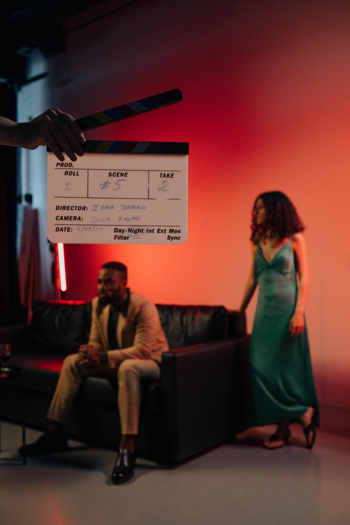 Actors on film set with clapperboard