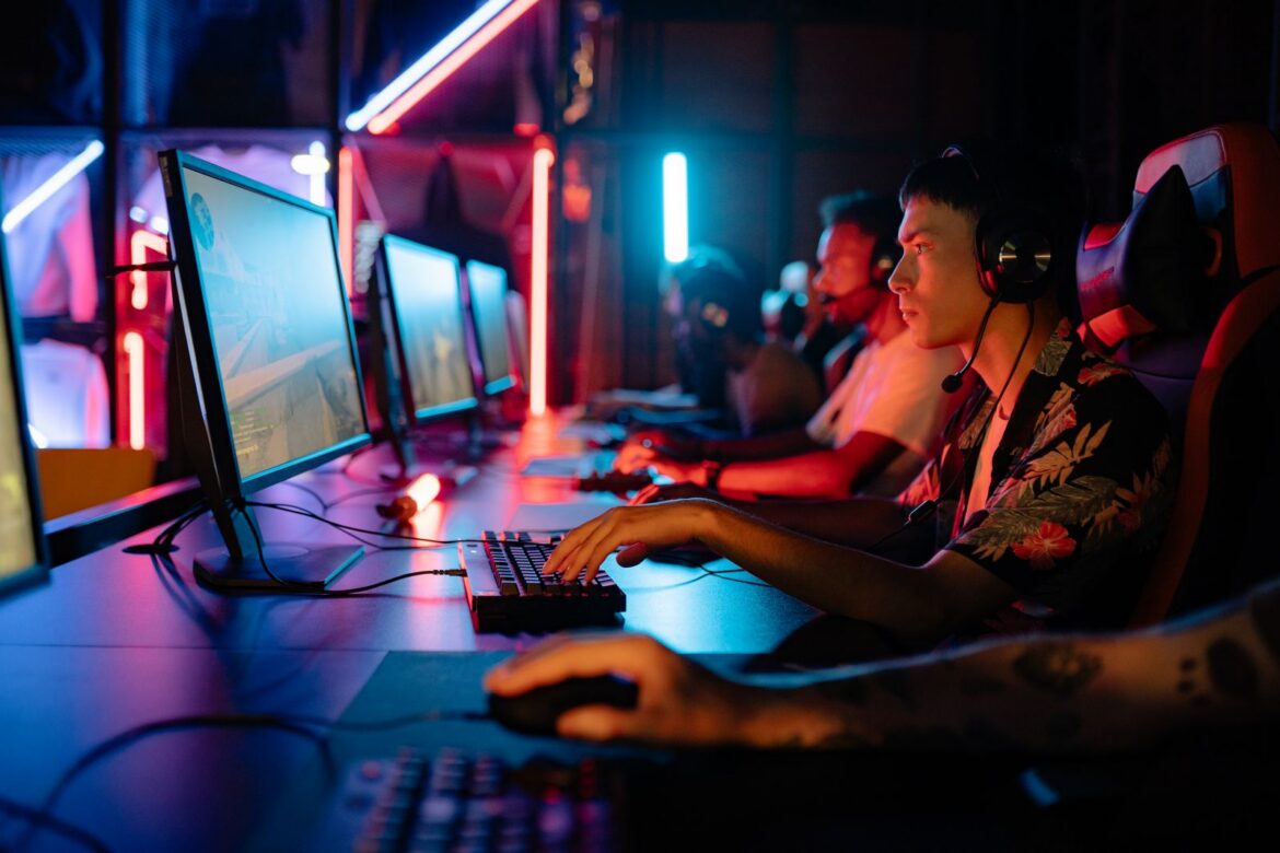 Group of gamers immersed in competitive esports at a cyber arena with neon lighting