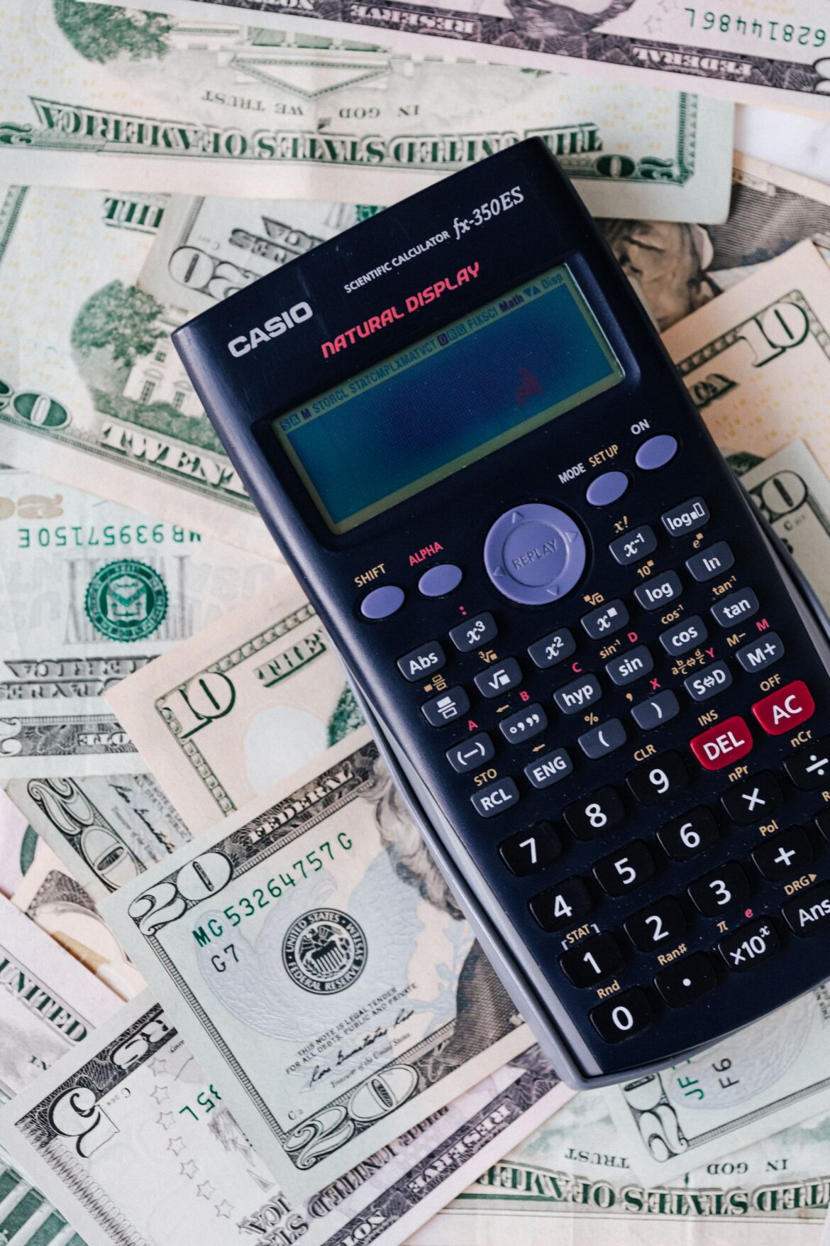 A calculator and bills on a table