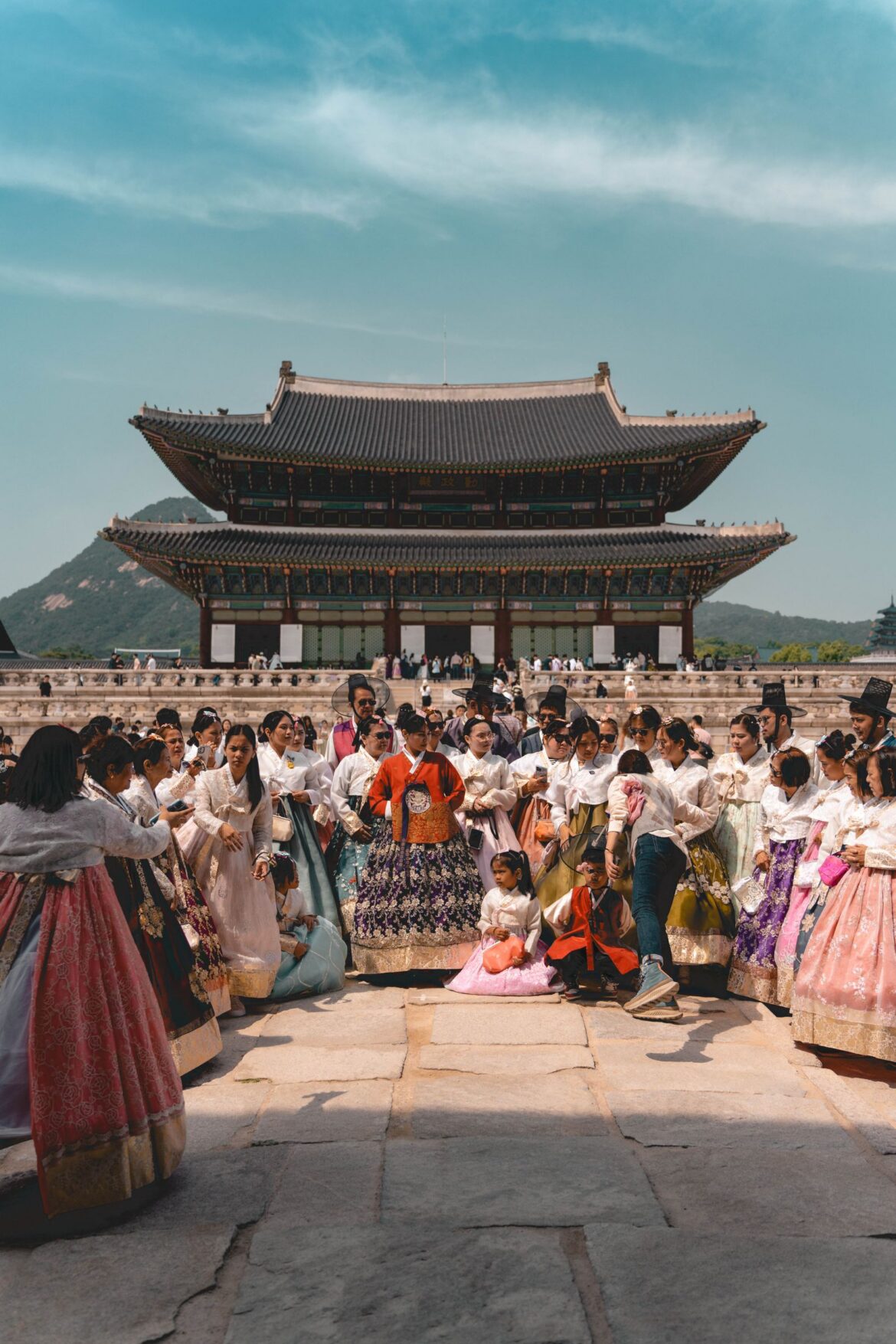 Crowd in traditional clothing at Gyeongbokgung Palace Seoul South Korea