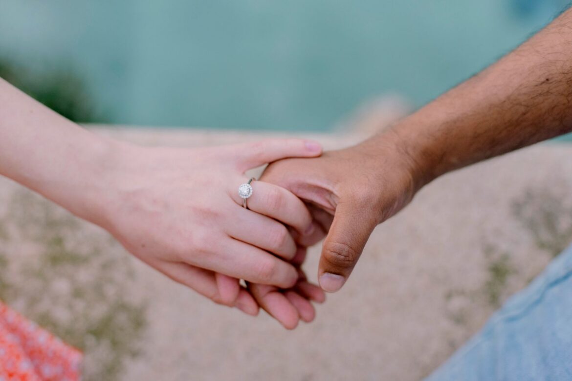 A couple holding hands together