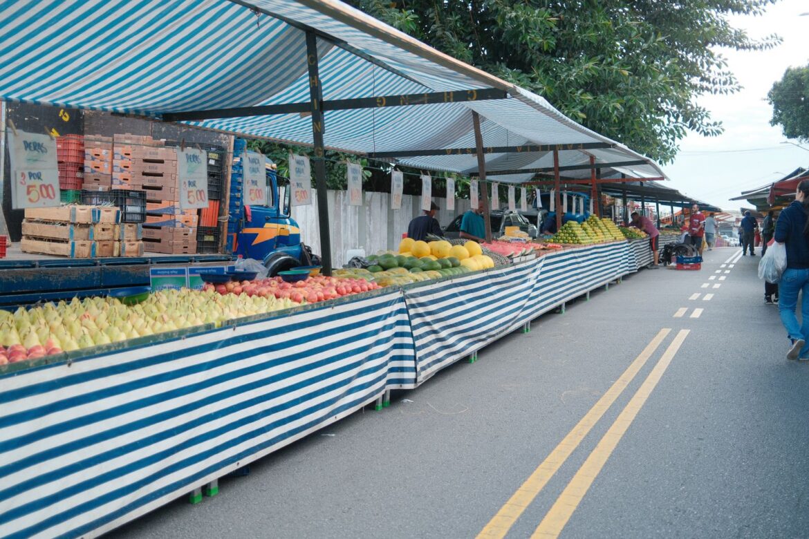 A vibrant outdoor fruit market scene