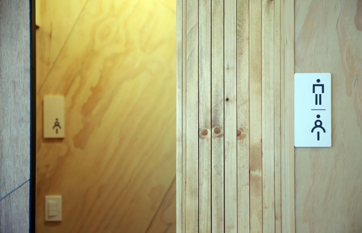 Cafe restroom door with signage, representing Korea pay-to-use restroom trend