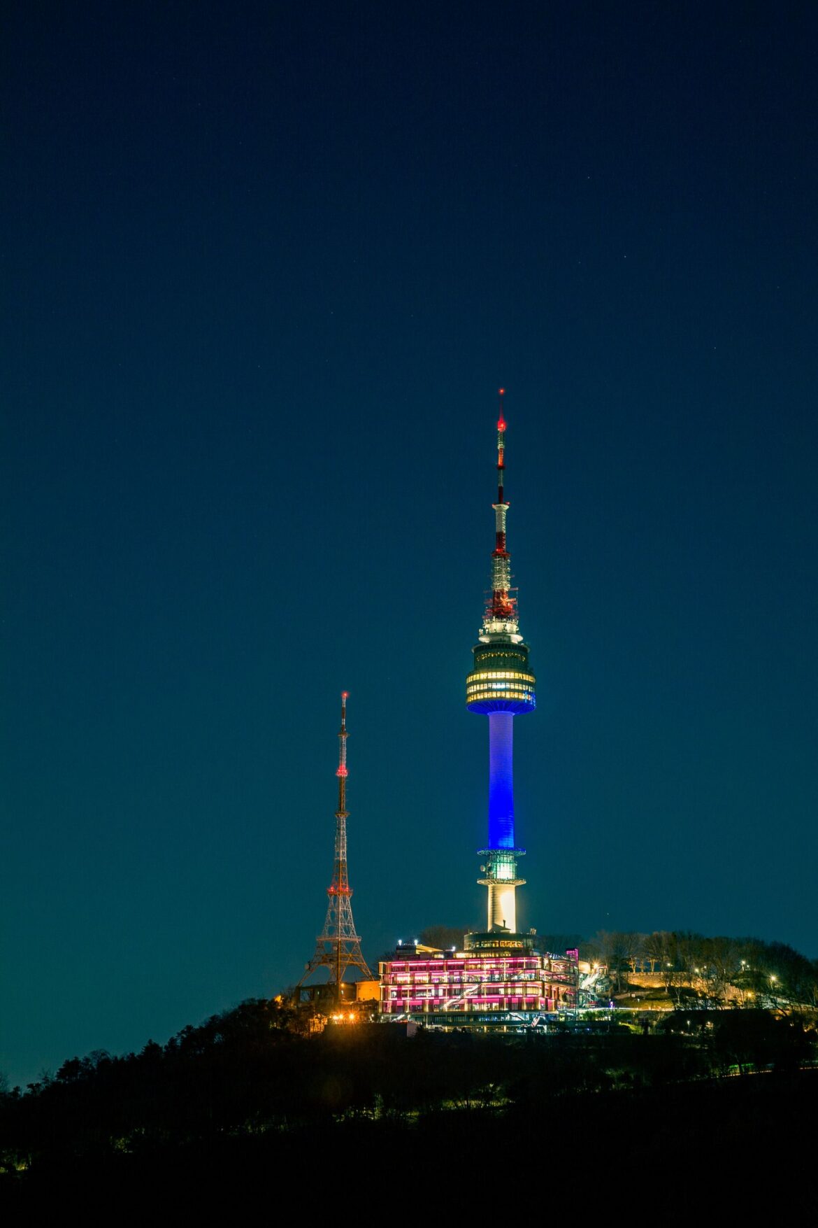 N Seoul Tower lit up at night, representing KPop Demon Hunters filming location tourism