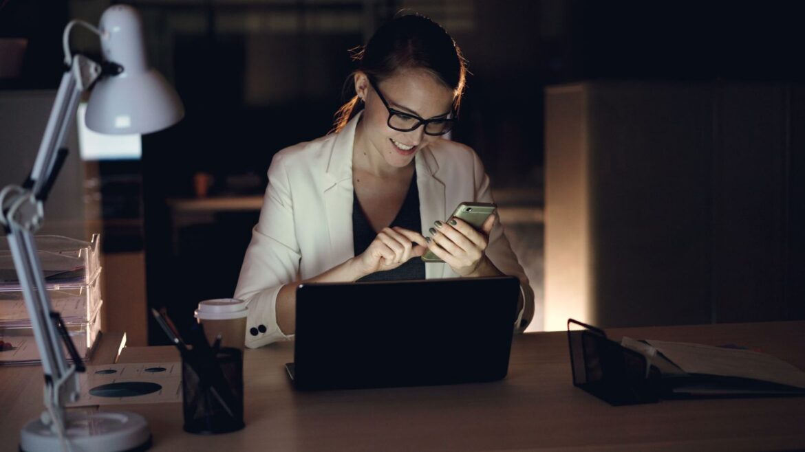 Employee checking a smartphone late at night, representing Korea proposed right-to-disconnect labor law