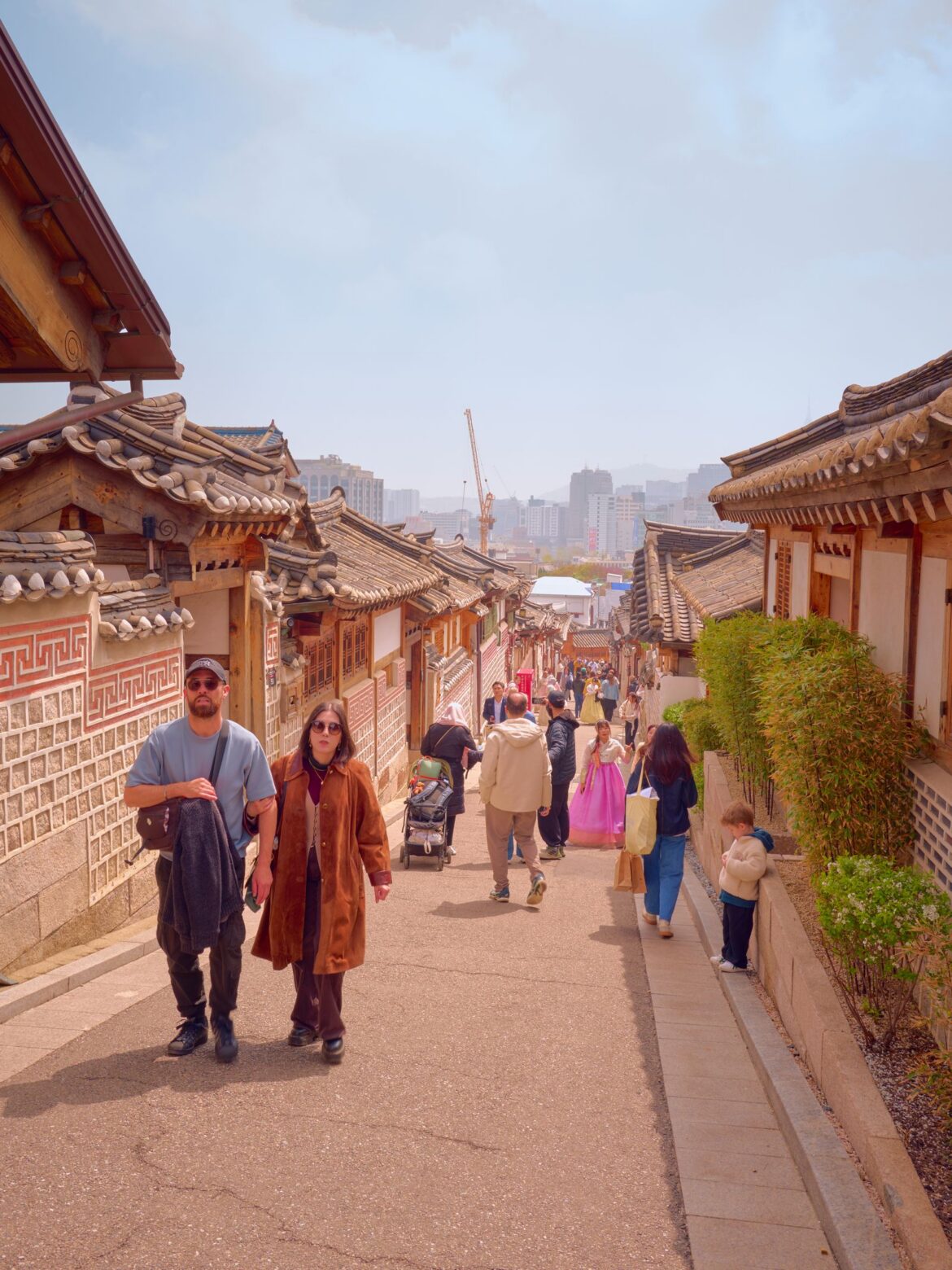Tourists at a traditional Korean site, representing the screen tourism boom around drama and film filming locations