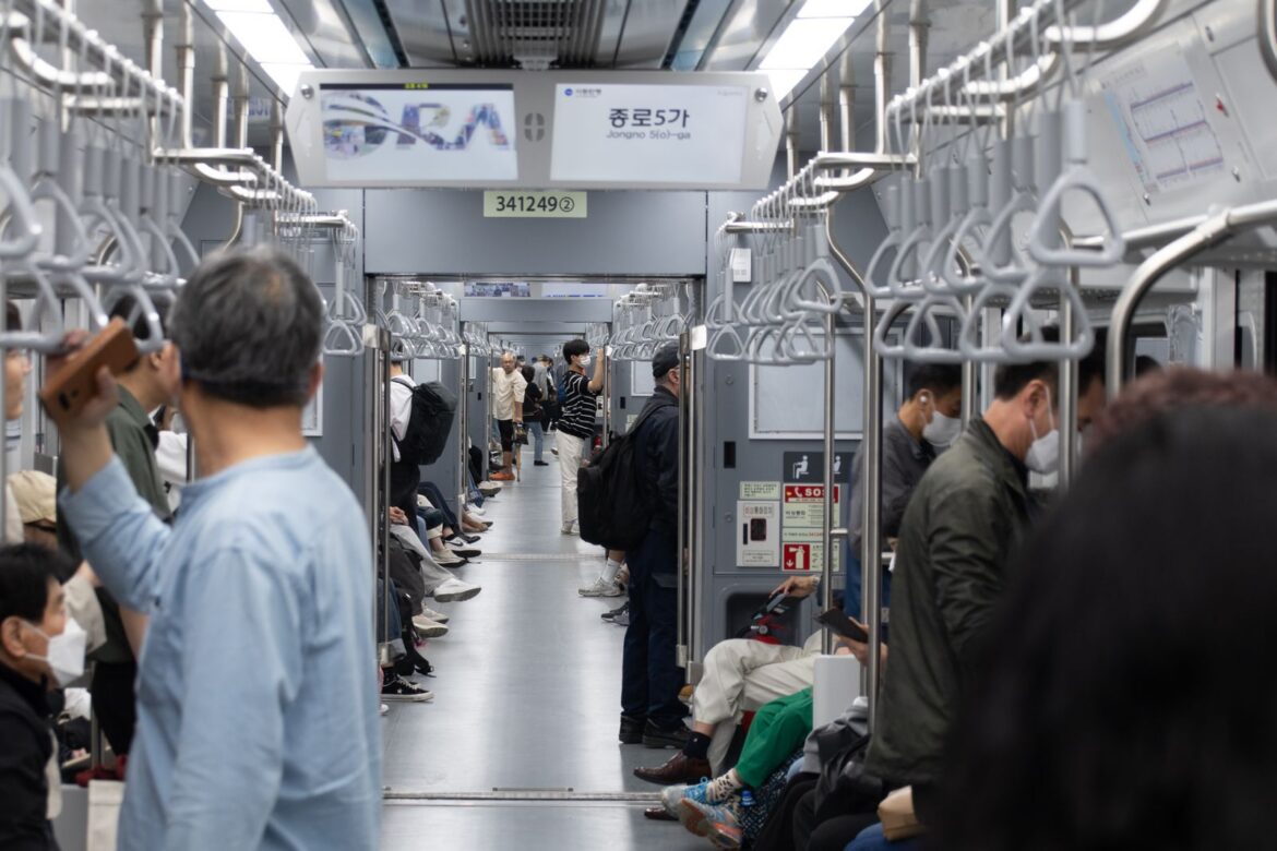 Interior of a Seoul subway carriage with commuters, representing Korea subway seating etiquette