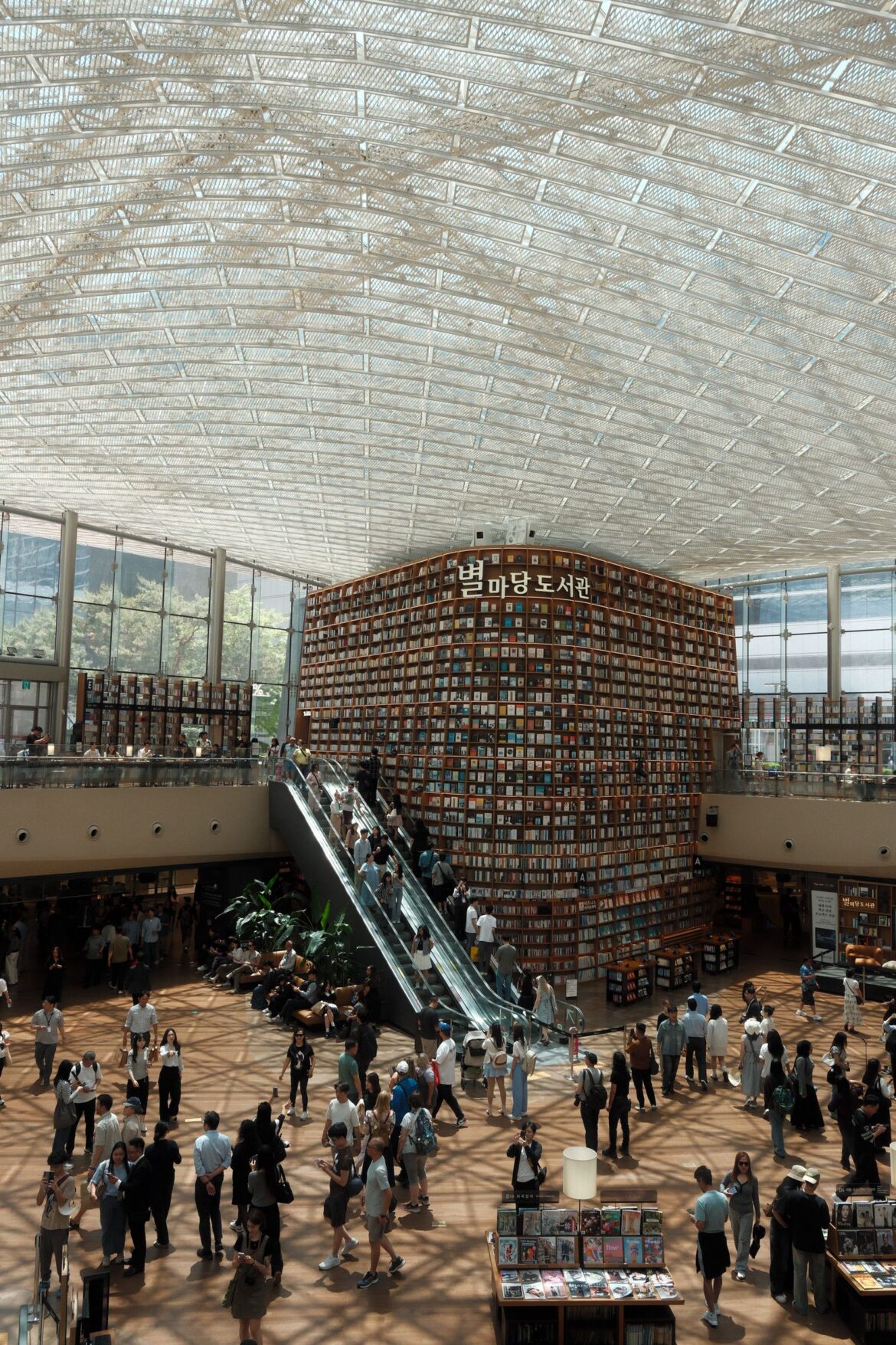 Bustling Korean library with escalator and books