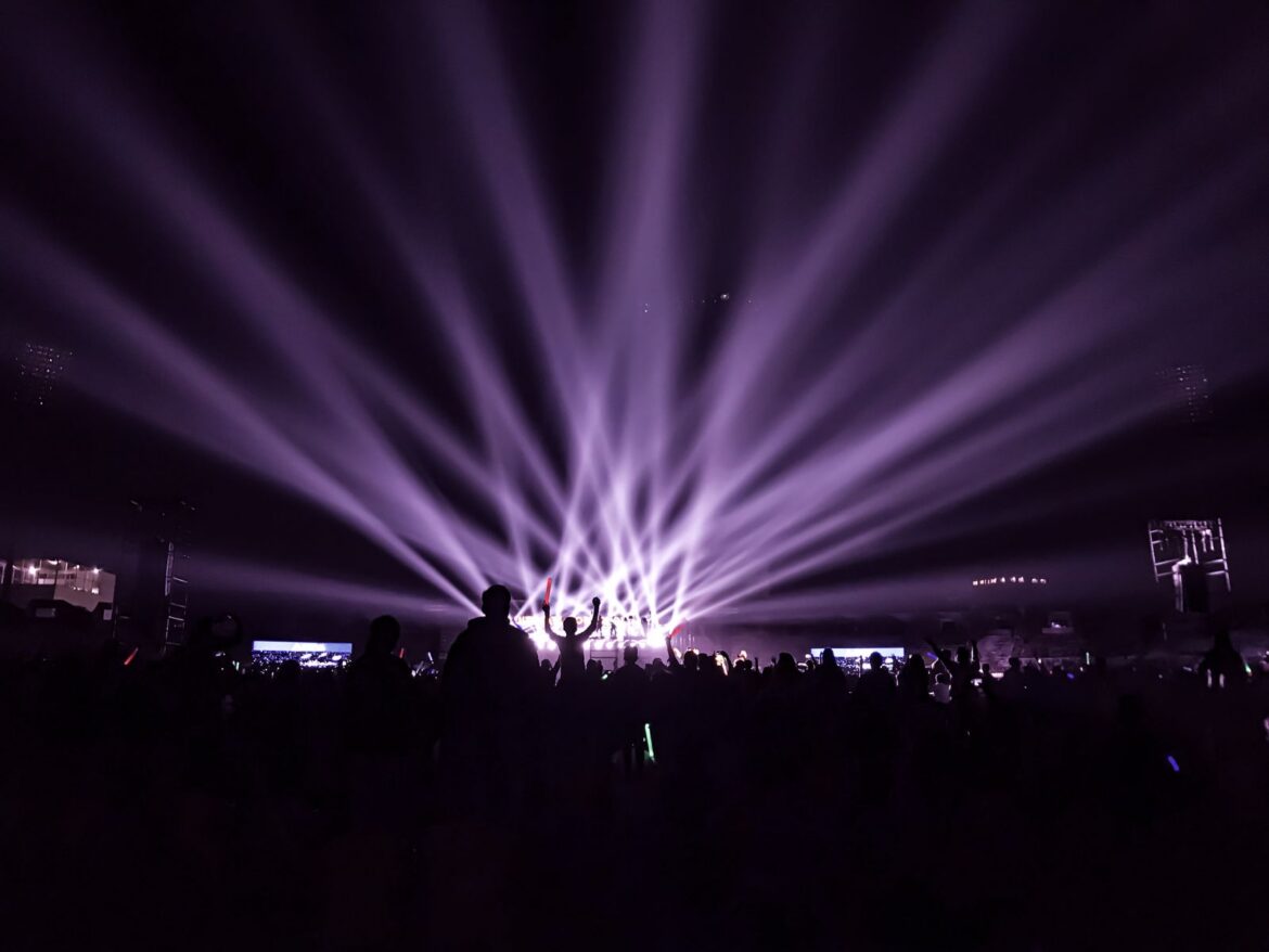 Concert with colorful lights and crowd, representing BTS Billboard 200 chart record