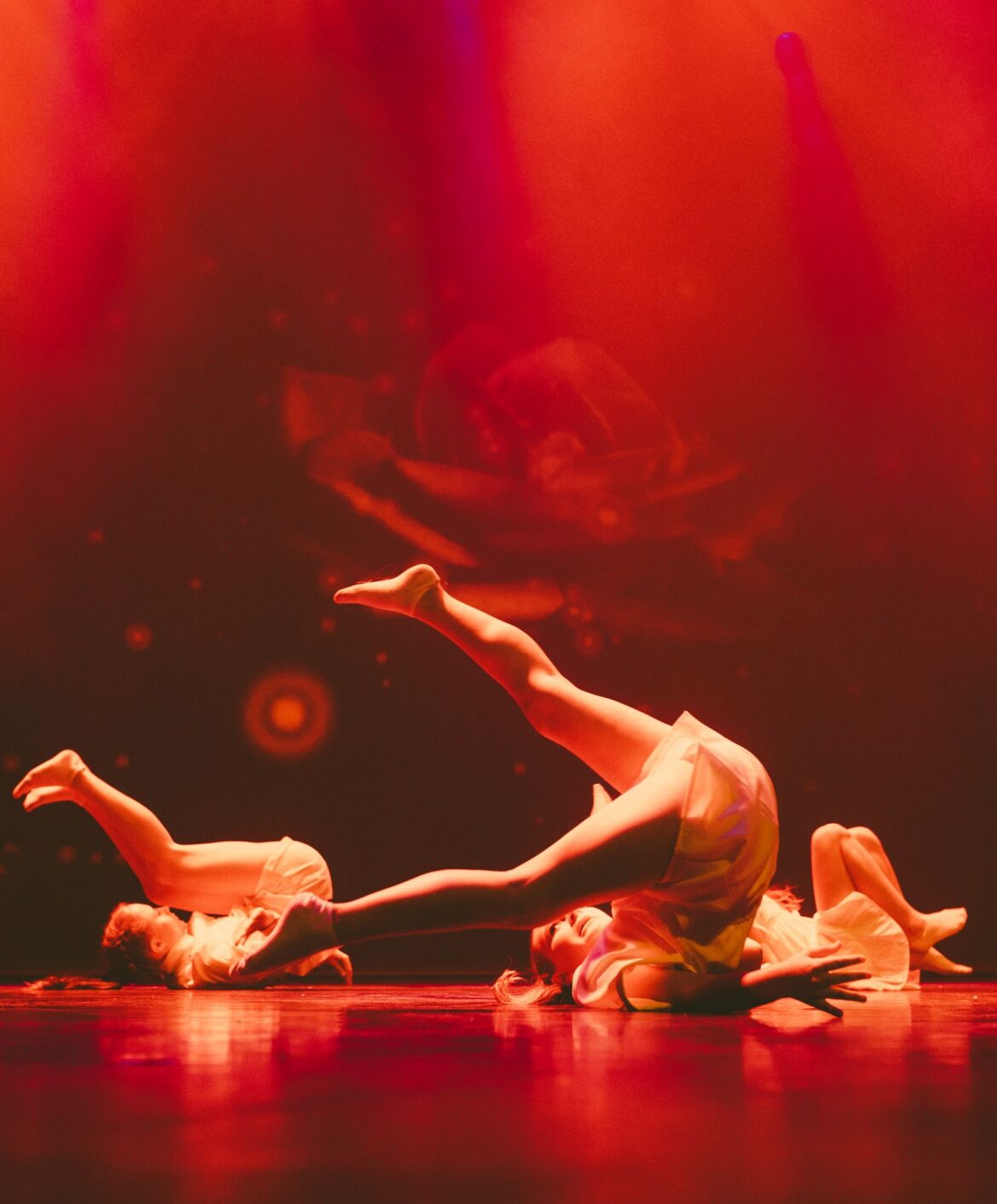 Performers on a dramatic concert stage, representing K-pop group MAMAMOO comeback