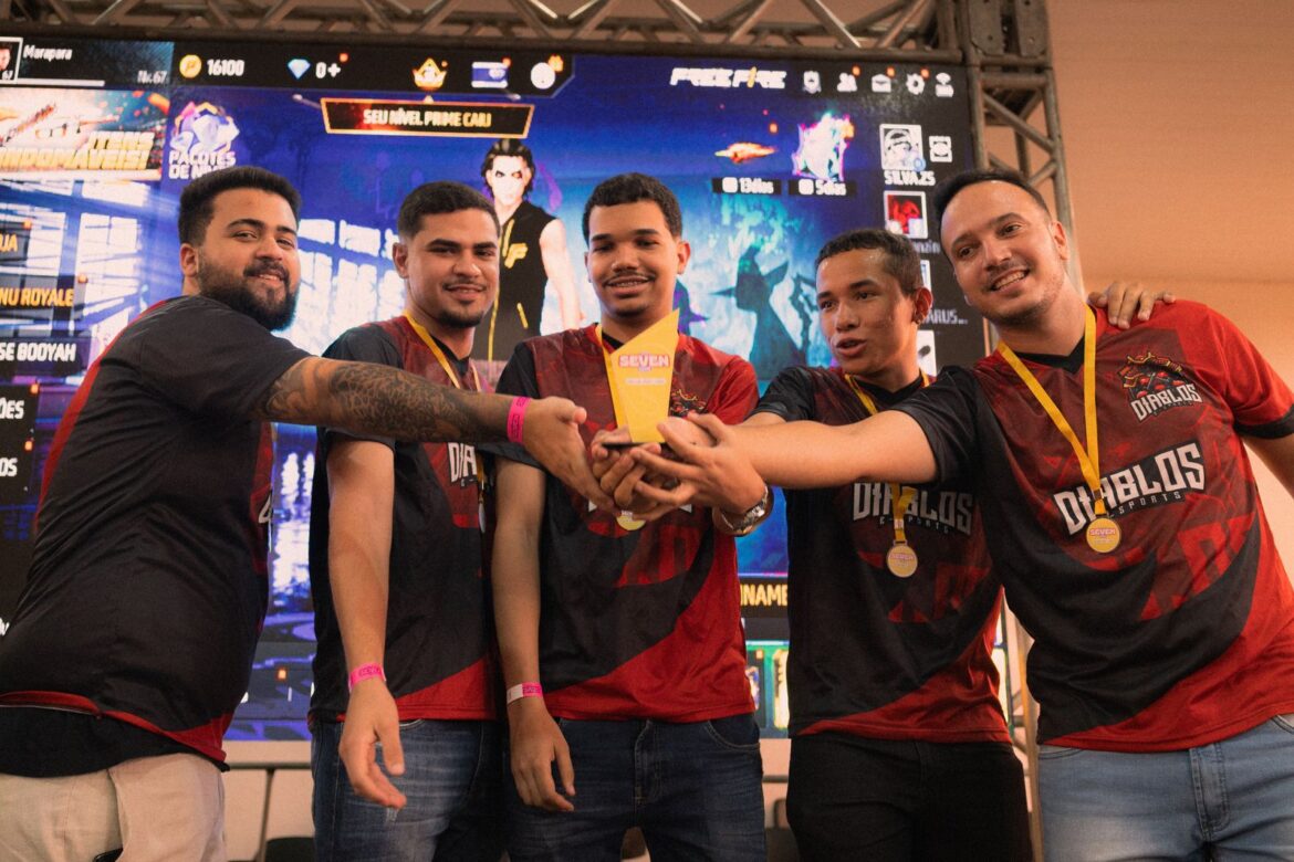 An esports team celebrating a victory with a trophy