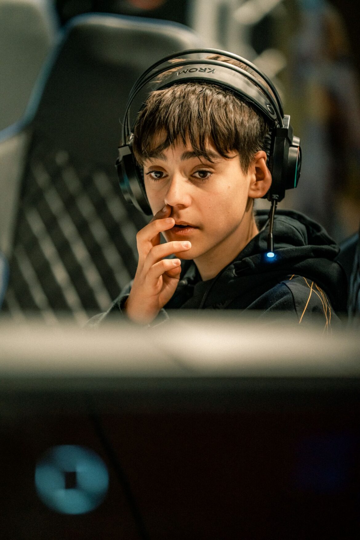 A teen gamer playing online at home