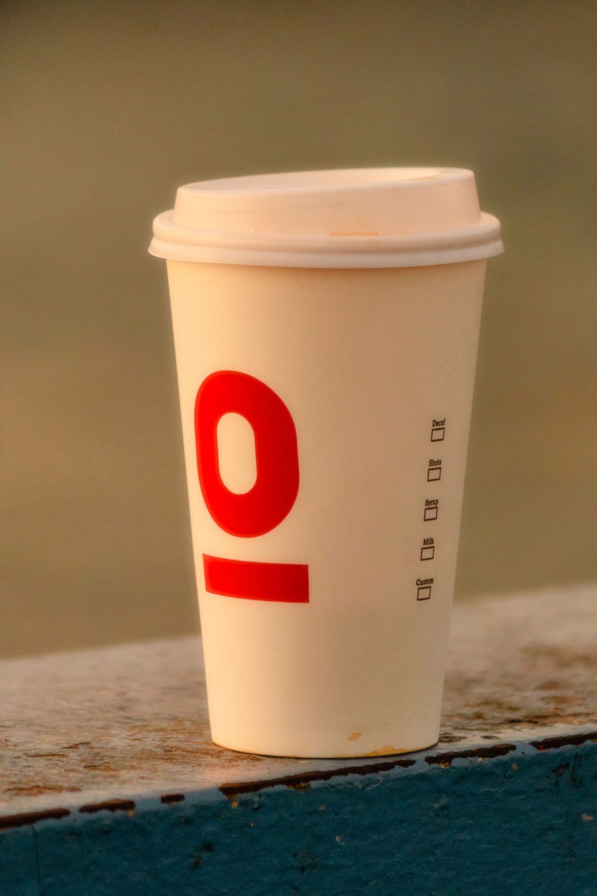 A disposable cup of to-go coffee