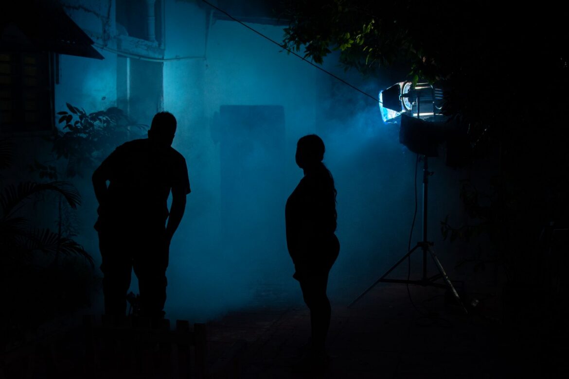 Silhouettes of a man and woman in the dark