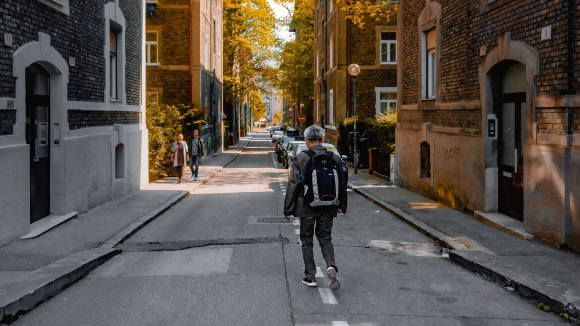 A man walking in a residential neighborhood