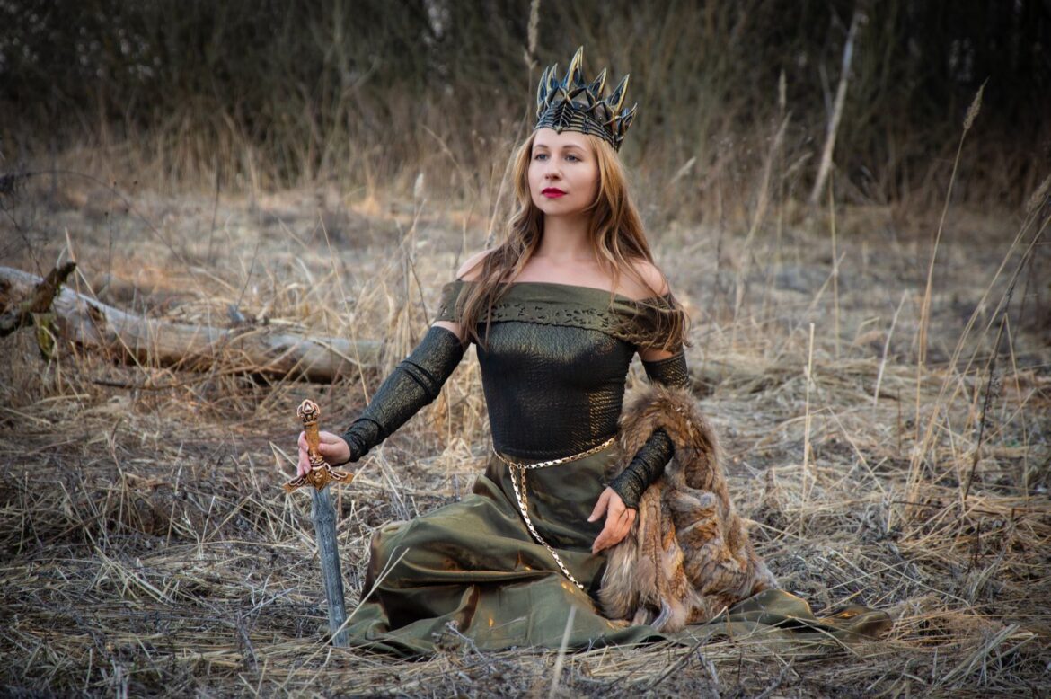 A medieval queen in a regal outdoor setting