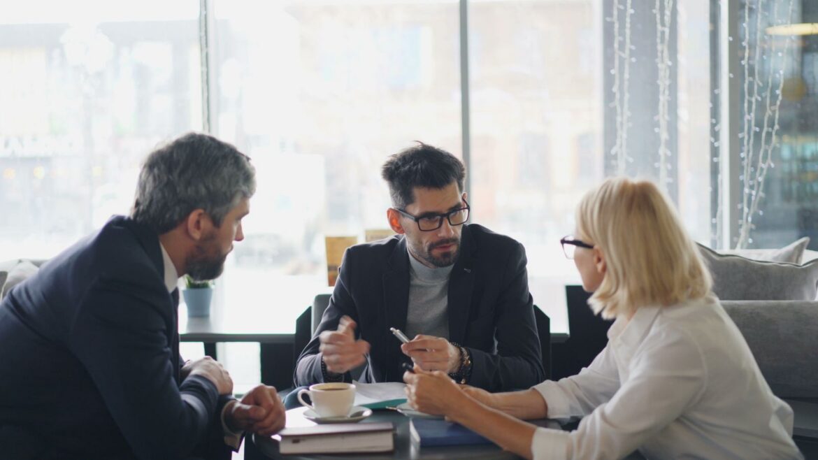 Colleagues talking at a table