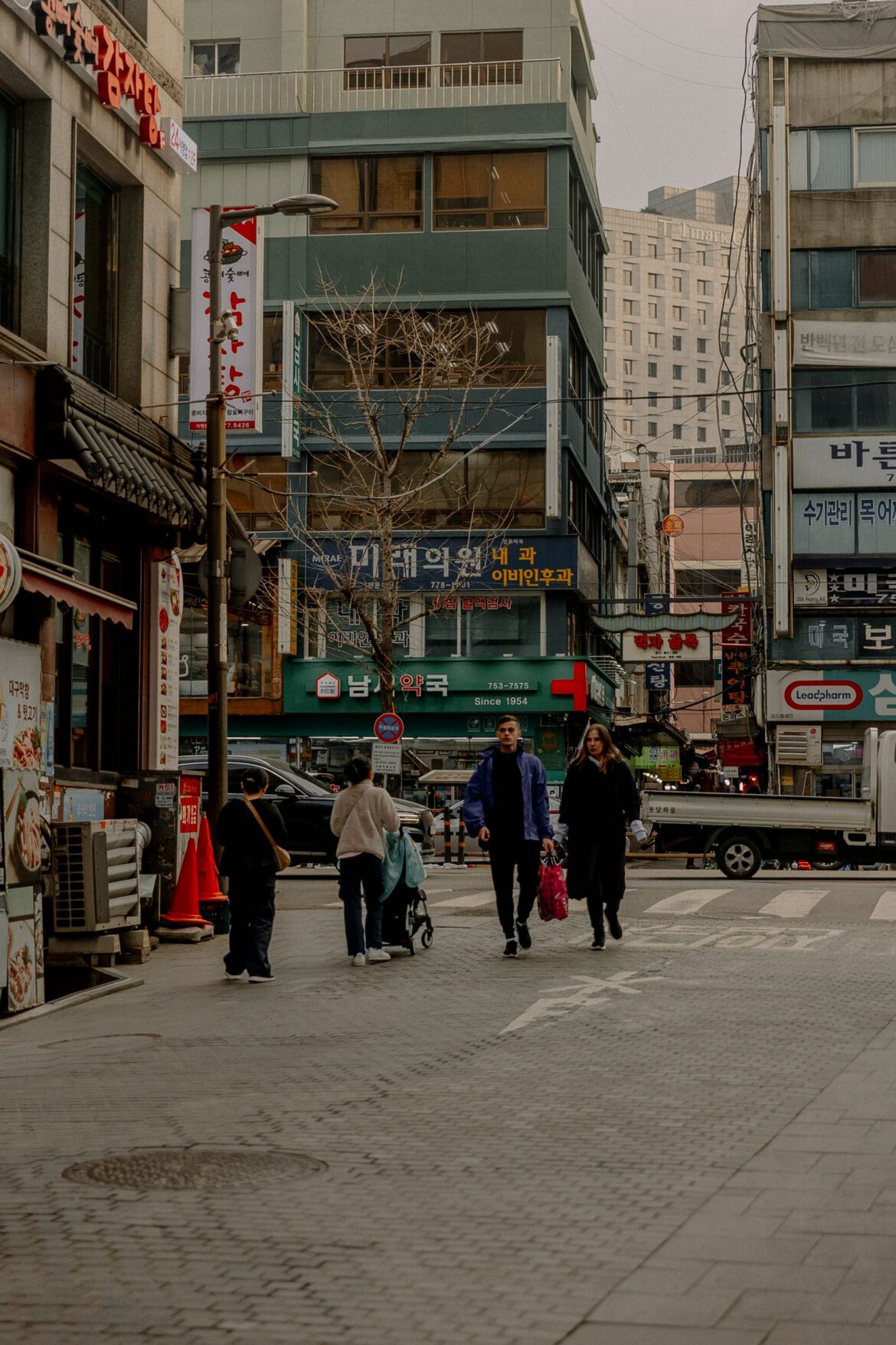 Vibrant street in Seoul showcasing local shops and pedestrians on a typical day