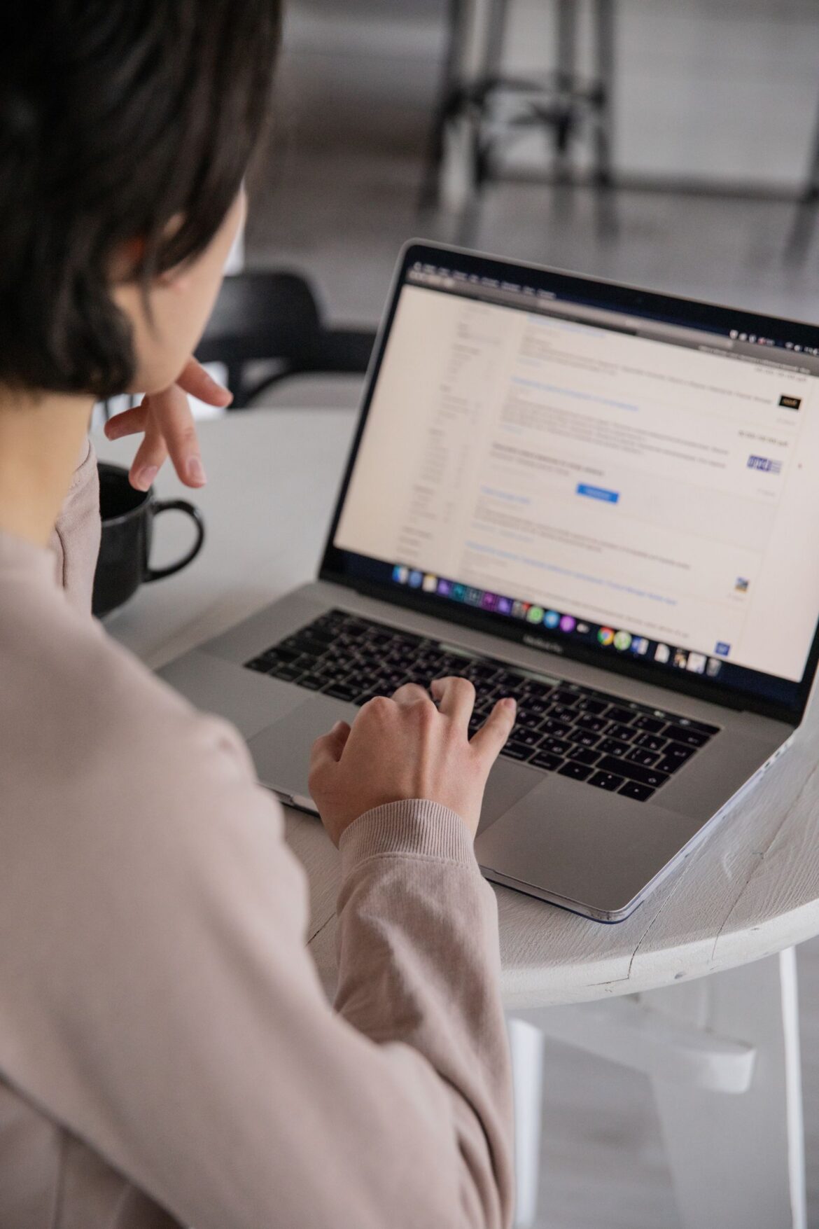 A young person searching for jobs on a laptop