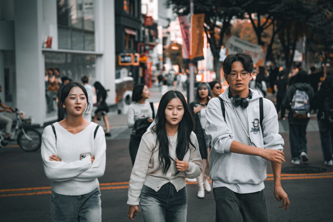 Young friends walking in bustling Seoul street