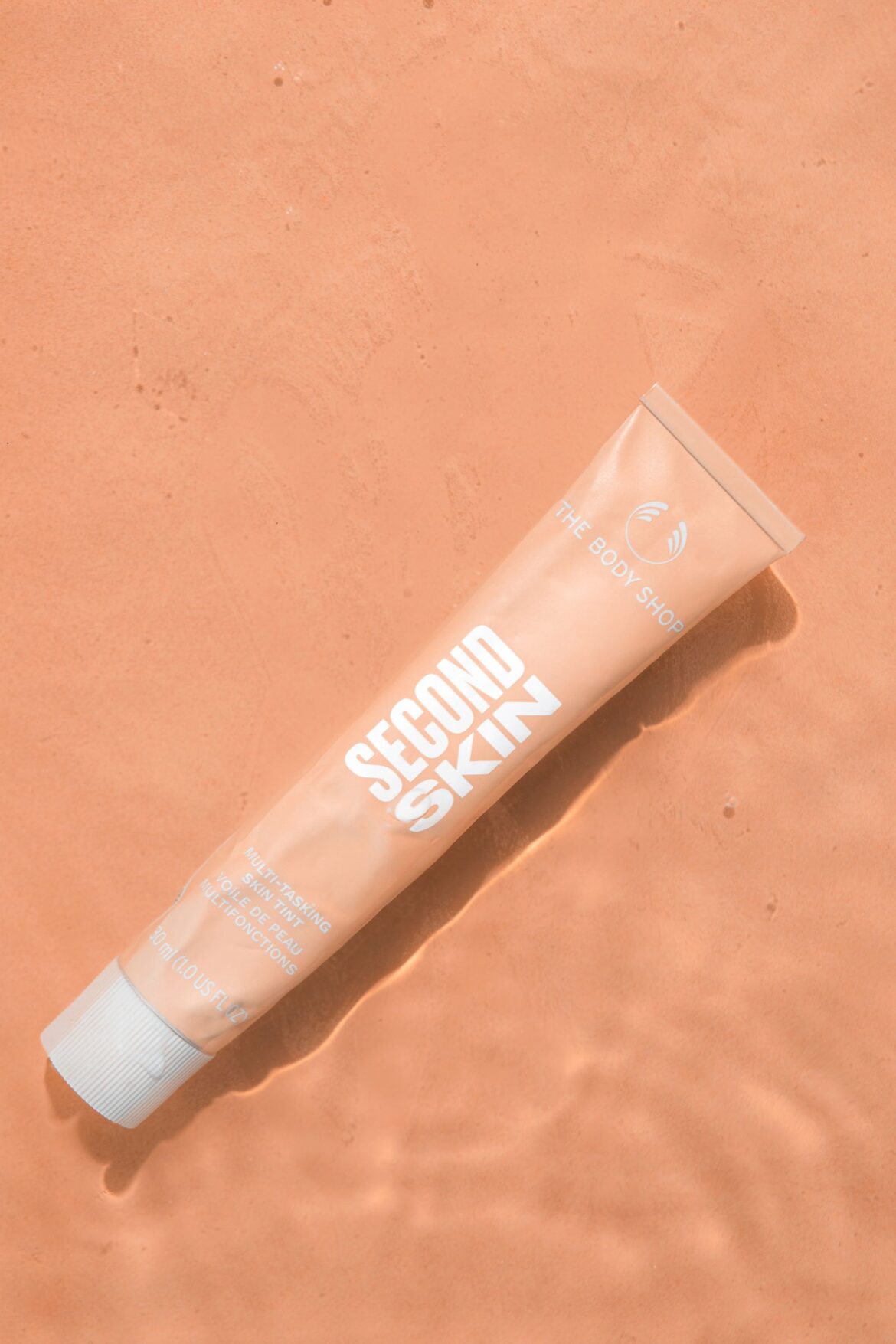A close-up of a tinted skin product tube