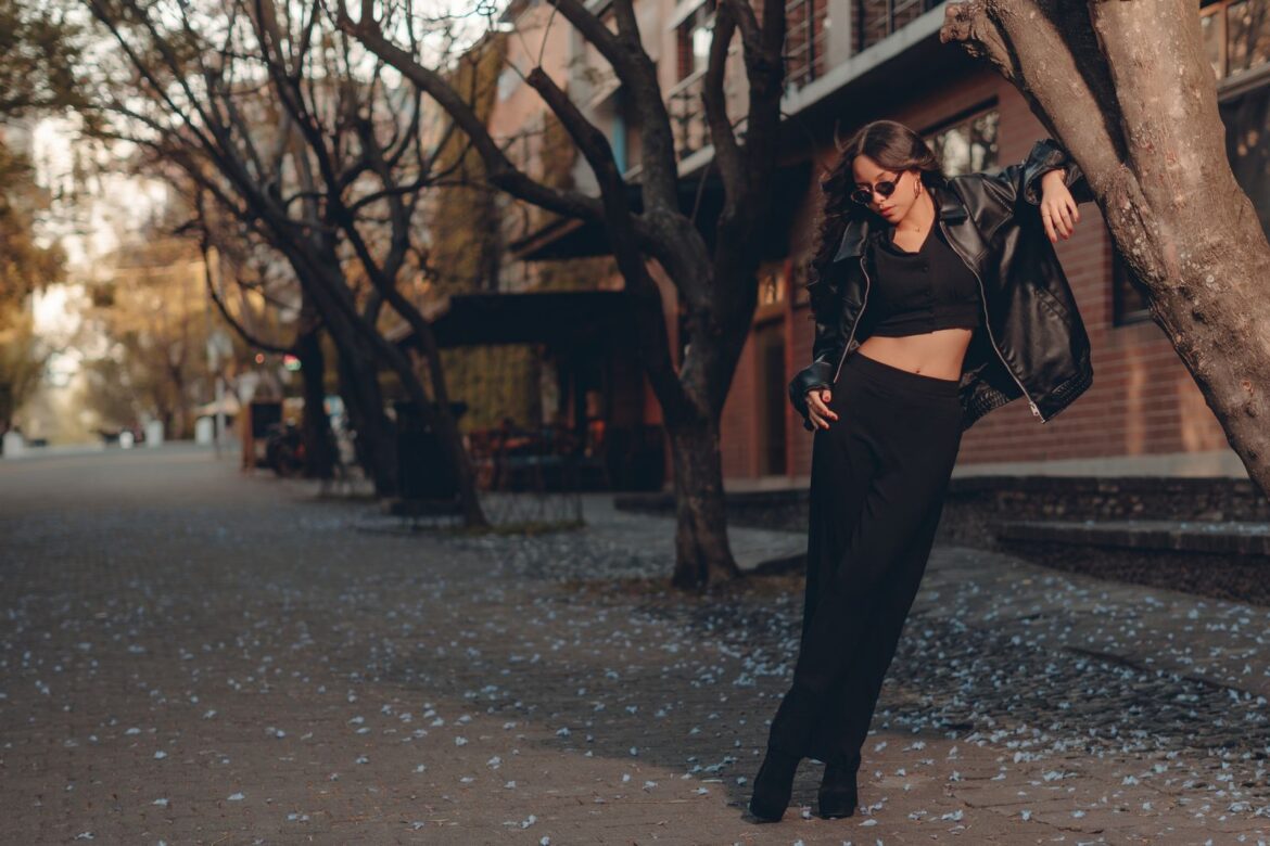 Stylish woman in black leather jacket on urban street