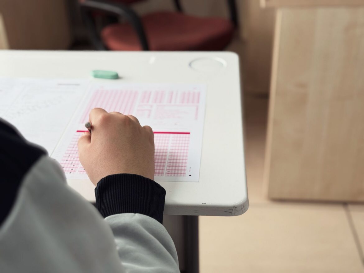Student taking a proficiency exam, representing the record surge in TOPIK Korean language test applicants