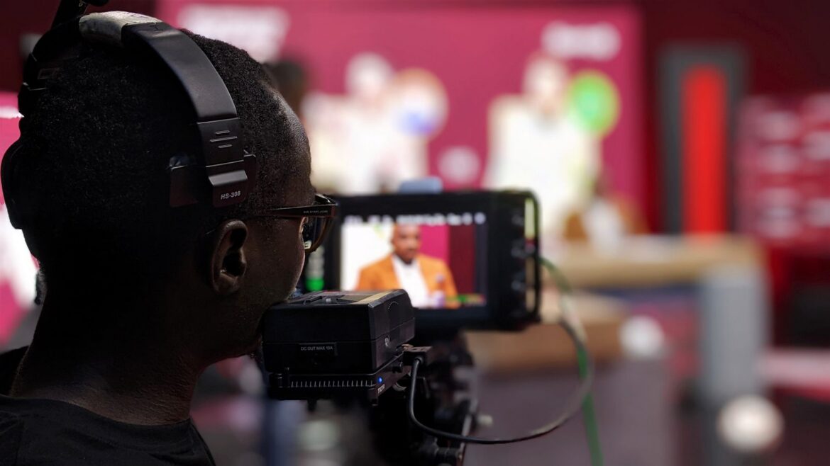 Cameraman with headphones filming in studio