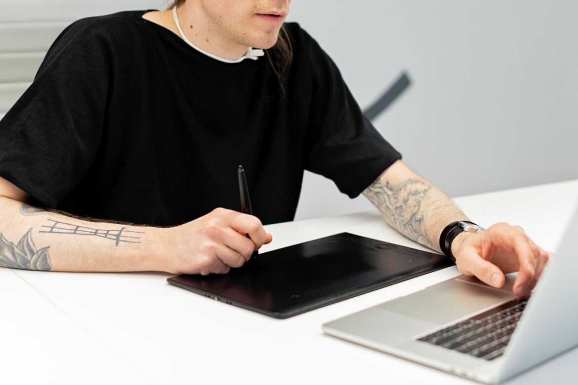 A digital artist drawing on a tablet