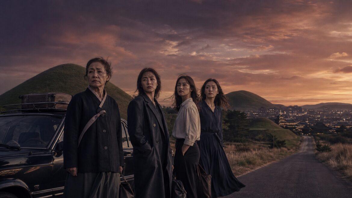 Four Korean women standing beside a car on a road to Gyeongju at dusk, film illustration